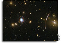 Hubble sees “Comet Galaxy” being ripped apart by galaxy cluster