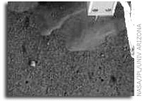 NASA’S Phoenix Lander Robotic Arm Camera Sees Possible Ice
